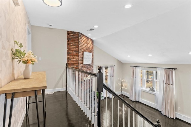 corridor featuring baseboards, a baseboard radiator, an upstairs landing, recessed lighting, and vaulted ceiling