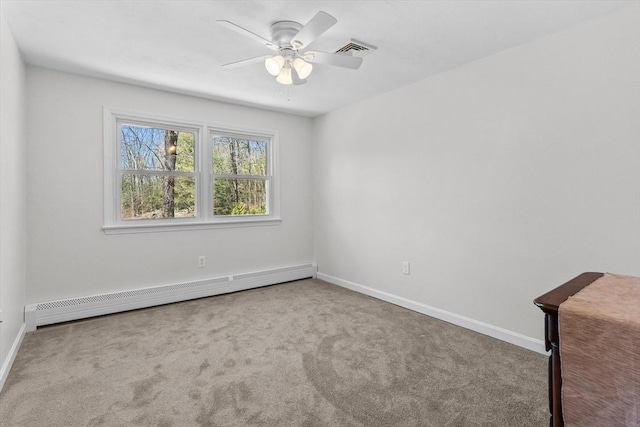 spare room with baseboard heating, carpet, ceiling fan, and baseboards