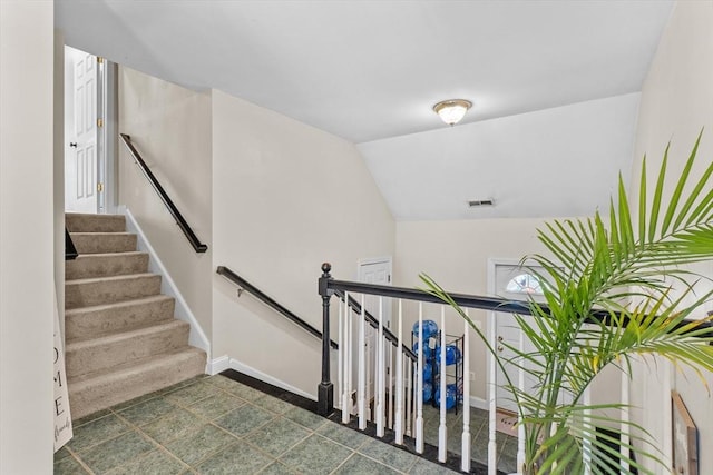stairs with baseboards and vaulted ceiling