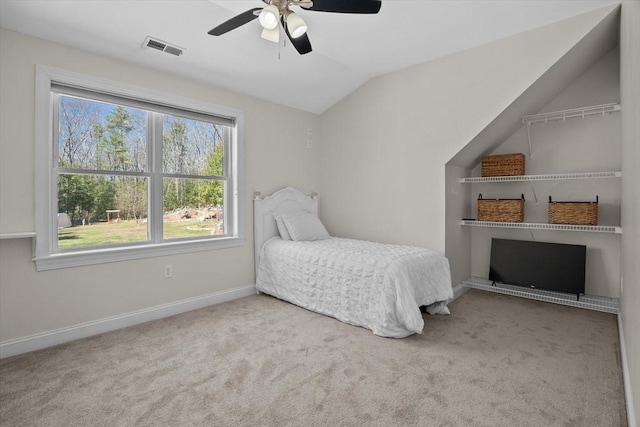 bedroom with lofted ceiling, carpet flooring, baseboards, and ceiling fan