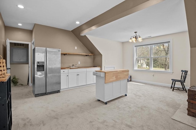 kitchen with stainless steel fridge with ice dispenser, a sink, light carpet, white cabinetry, and recessed lighting