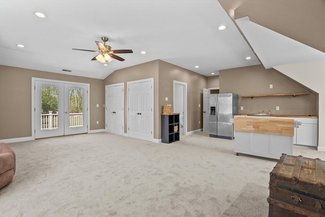living area featuring a ceiling fan, baseboards, light carpet, recessed lighting, and french doors