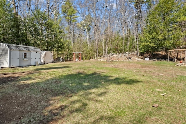 view of green lawn featuring a shed and an outdoor structure