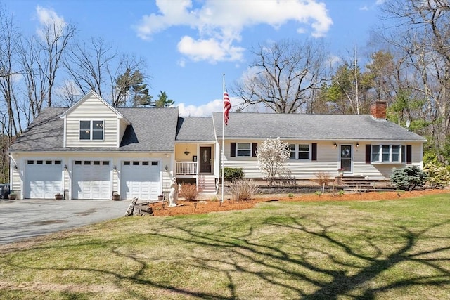 view of front of house featuring driveway, an attached garage, a front lawn, and a chimney