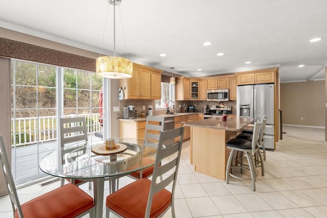 3 Jasmine Dr, Oxford, MA 01540 - kitchen featuring stainless steel appliances, glass insert cabinets, a center island, backsplash, and ornamental molding