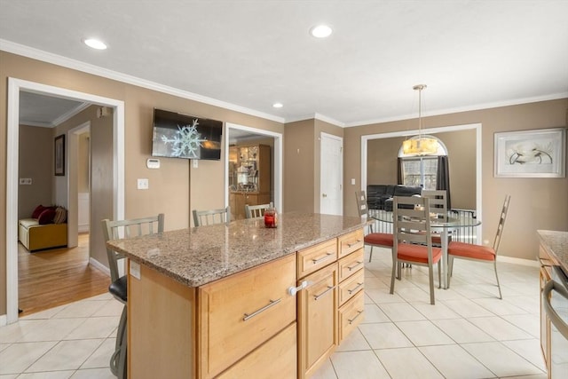 3 Jasmine Dr, Oxford, MA 01540 - kitchen with light tile patterned flooring, a center island, light stone counters, baseboards, and ornamental molding