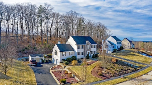 3 Jasmine Dr, Oxford, MA 01540 - view of front of house featuring a chimney, aphalt driveway, and a garage