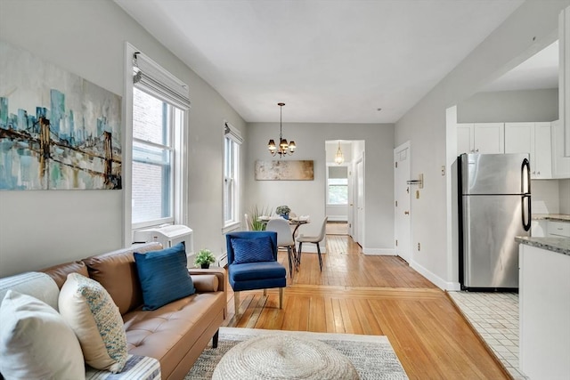 79 Revere St Unit 4, Boston, MA 02114 - living area with a chandelier, healthy amount of natural light, and light wood-type flooring