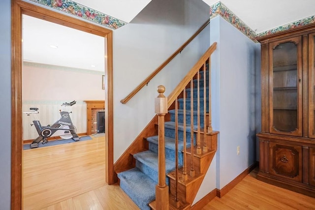 stairs with baseboards and wood finished floors