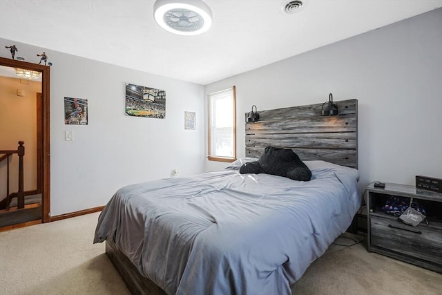 carpeted bedroom featuring visible vents and baseboards