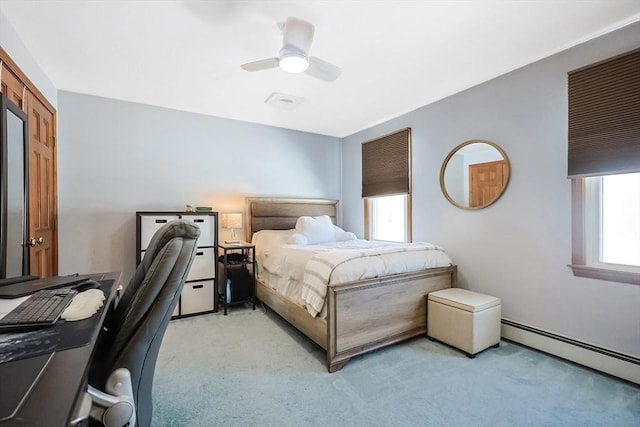 bedroom featuring light carpet, ceiling fan, and baseboard heating