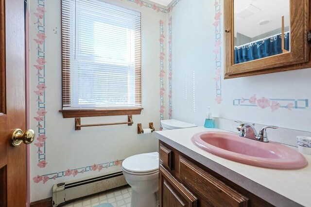 full bathroom with baseboard heating, vanity, and toilet