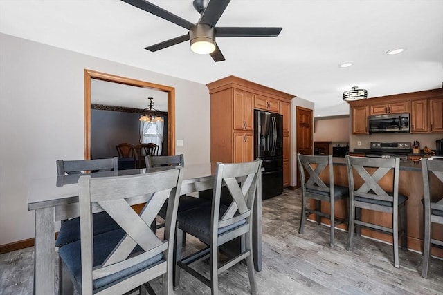 dining room featuring light wood-style floors, recessed lighting, baseboards, and ceiling fan with notable chandelier