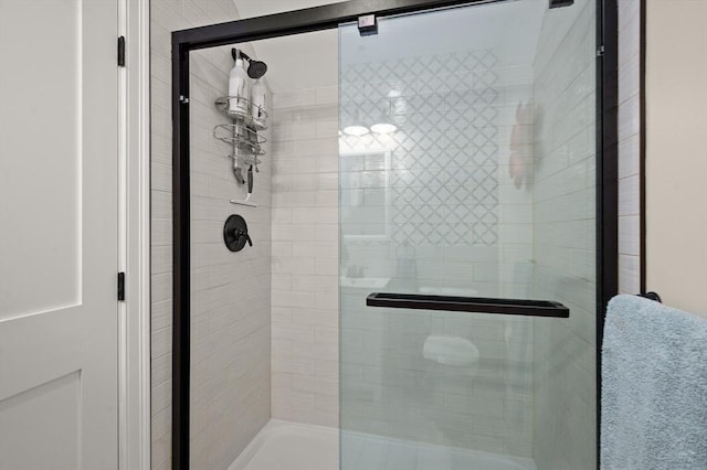 bathroom featuring a shower with door