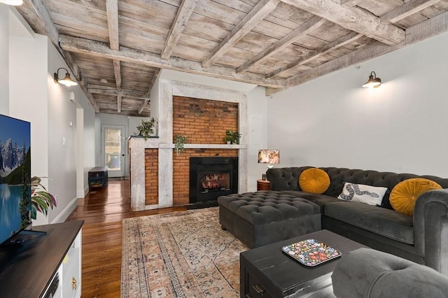 living room with wood ceiling, dark hardwood / wood-style floors, beamed ceiling, and a fireplace