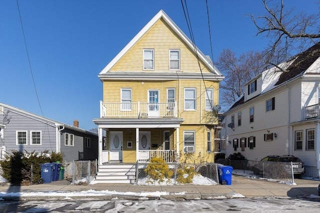 front of property with a balcony and covered porch