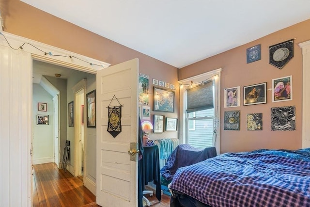 bedroom with dark wood-type flooring