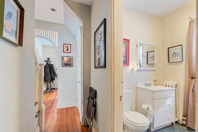 bathroom featuring vanity, hardwood / wood-style floors, and toilet