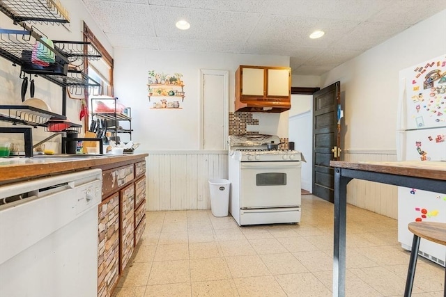 kitchen with white appliances, a paneled ceiling, and sink