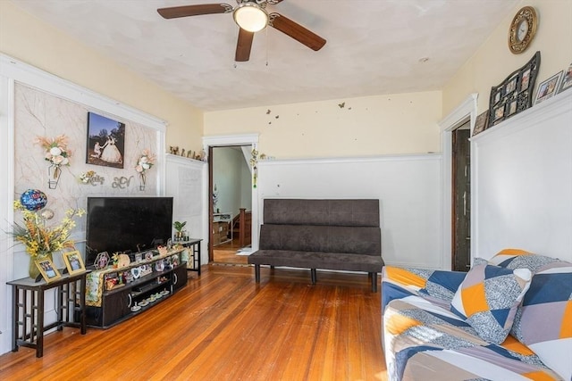 living room with ceiling fan and hardwood / wood-style floors