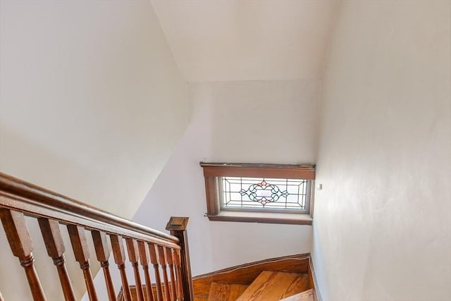 staircase featuring vaulted ceiling