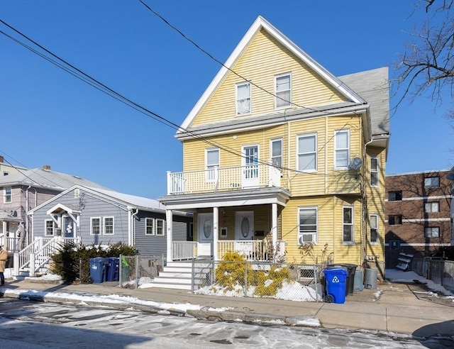 front of property featuring cooling unit, a balcony, and covered porch