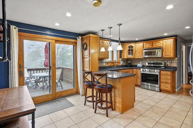 93 Lincoln Ave, Ashburnham, MA 01430 - kitchen with stainless steel appliances, dark countertops, a peninsula, tasteful backsplash, and a textured ceiling