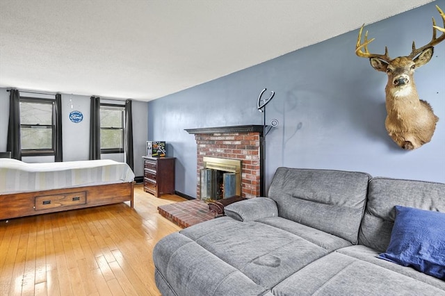 93 Lincoln Ave, Ashburnham, MA 01430 - living area featuring hardwood / wood-style floors and a brick fireplace