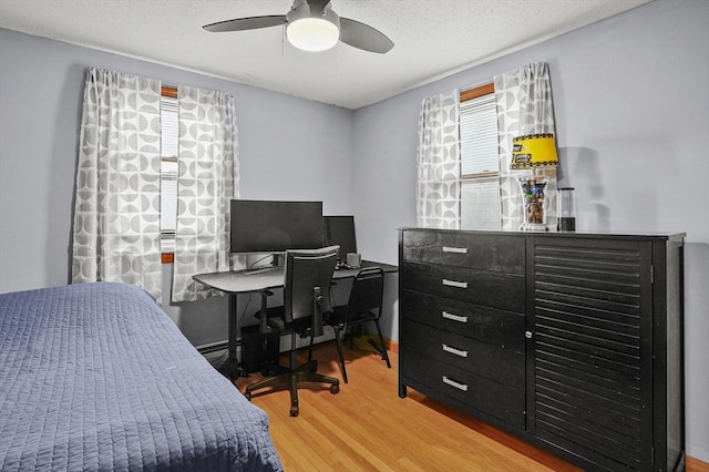 93 Lincoln Ave, Ashburnham, MA 01430 - bedroom featuring multiple windows, wood finished floors, a ceiling fan, and a baseboard heating unit