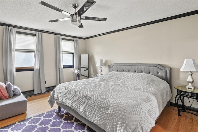 93 Lincoln Ave, Ashburnham, MA 01430 - bedroom with wood finished floors, a textured ceiling, crown molding, a ceiling fan, and a baseboard heating unit