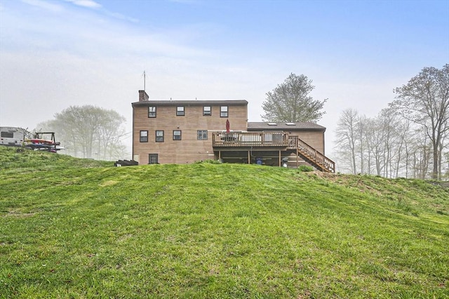 93 Lincoln Ave, Ashburnham, MA 01430 - rear view of property featuring stairway, a deck, a lawn, and a chimney
