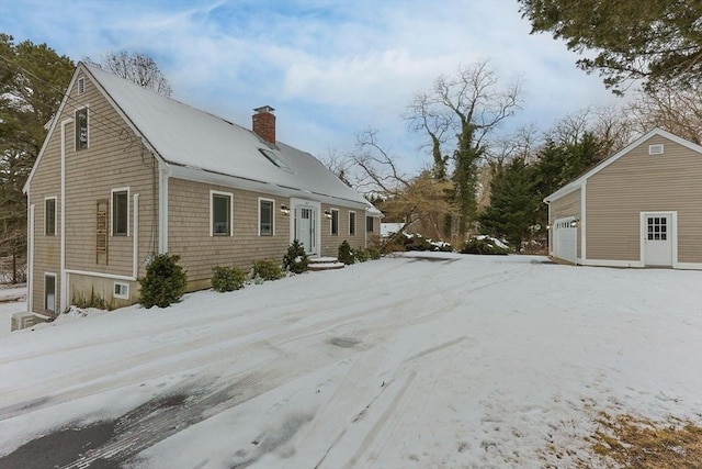 view of snowy exterior featuring a garage