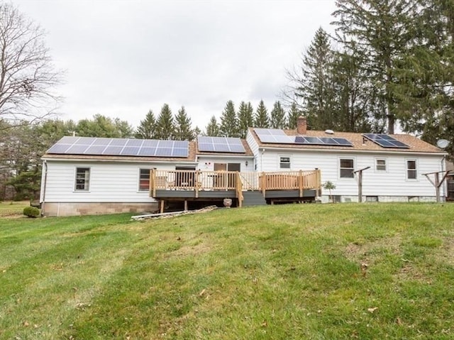 back of house with a wooden deck and a lawn