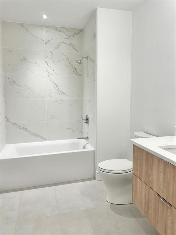 bathroom with tub / shower combination, vanity, and toilet