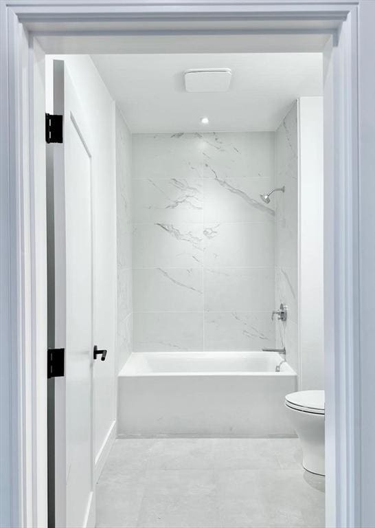 bathroom featuring washtub / shower combination and toilet