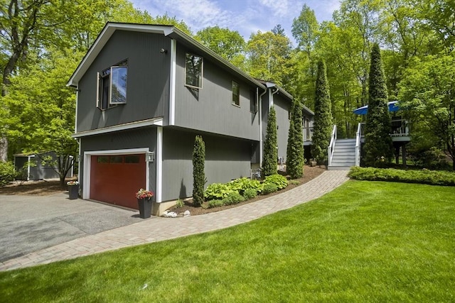21 Birch Ln, Northampton, MA 01062 - view of property exterior featuring a garage, stairs, a lawn, and asphalt driveway