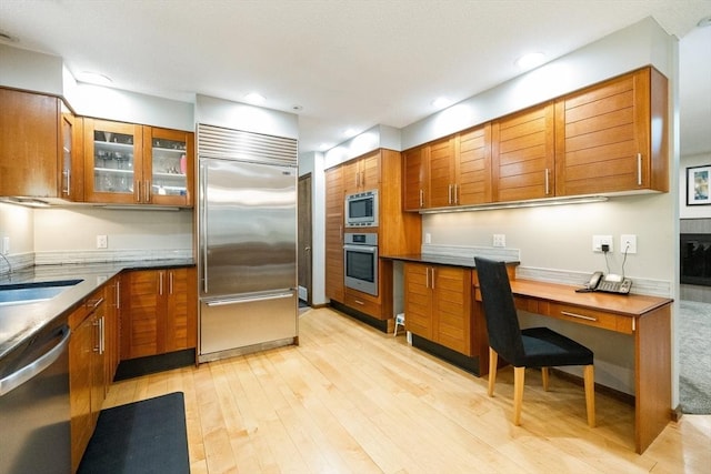 21 Birch Ln, Northampton, MA 01062 - kitchen with built in appliances, brown cabinetry, light wood-type flooring, and recessed lighting