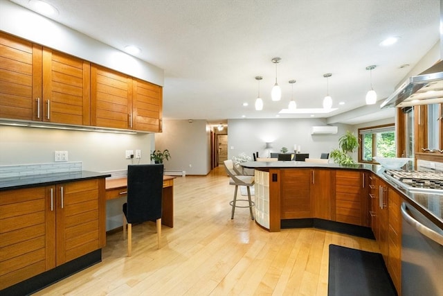 21 Birch Ln, Northampton, MA 01062 - kitchen with stainless steel appliances, brown cabinets, light wood-type flooring, an AC wall unit, and recessed lighting