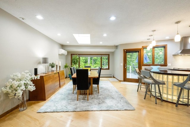 21 Birch Ln, Northampton, MA 01062 - dining space featuring a wall mounted AC, light wood-style floors, a skylight, recessed lighting, and baseboards