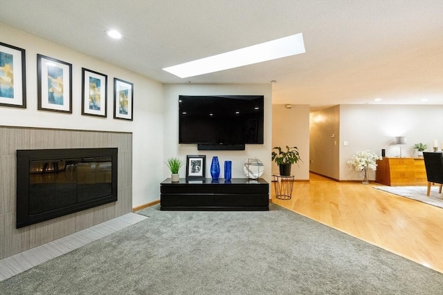 21 Birch Ln, Northampton, MA 01062 - living area featuring carpet, a fireplace, a skylight, and recessed lighting