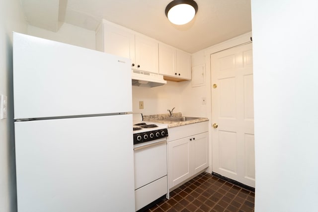 kitchen with white appliances, white cabinetry, and sink