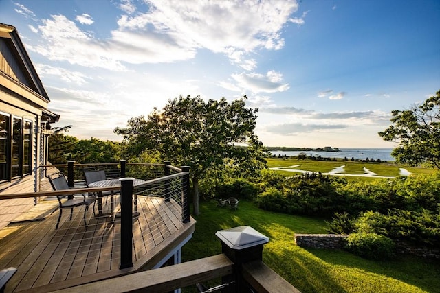 wooden deck featuring a yard and a water view