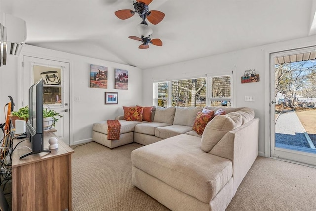 living room featuring lofted ceiling, a wall unit AC, a ceiling fan, and light colored carpet