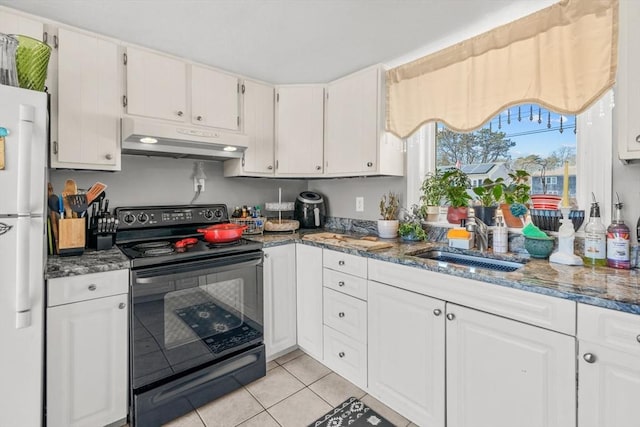 kitchen featuring electric range, freestanding refrigerator, white cabinets, a sink, and under cabinet range hood