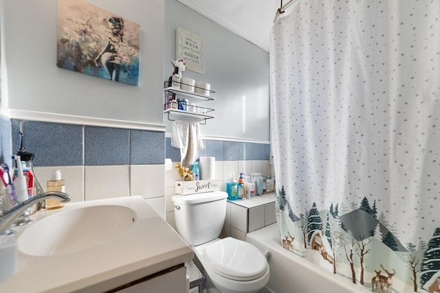 full bathroom featuring vanity, toilet, tile walls, and shower / bath combo