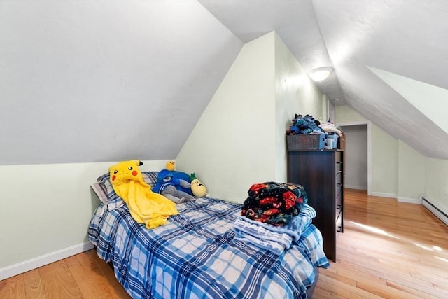 bedroom with lofted ceiling and wood-type flooring