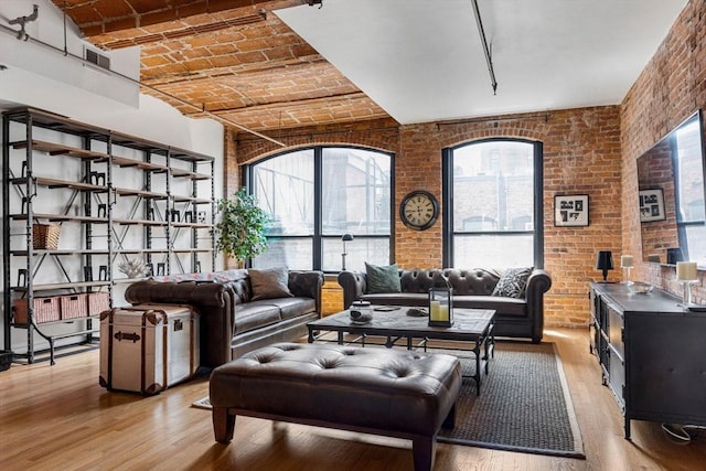 121-123 Beach St Unit 603, Boston, MA 02111 - living room with light wood-type flooring, brick ceiling, healthy amount of natural light, and brick wall