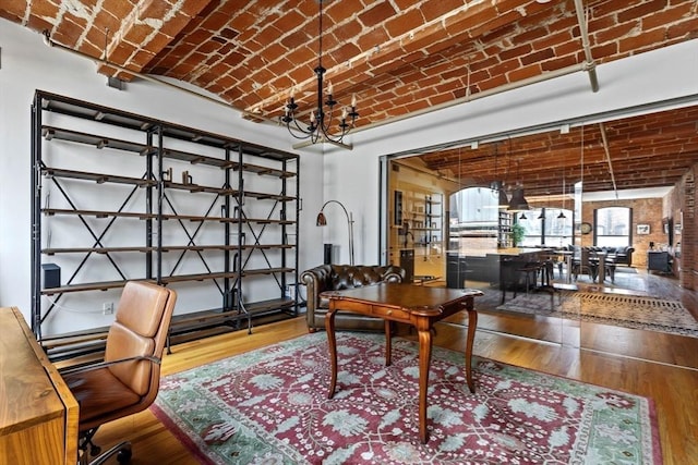 121-123 Beach St Unit 603, Boston, MA 02111 - office with brick ceiling, a chandelier, wood finished floors, and brick wall