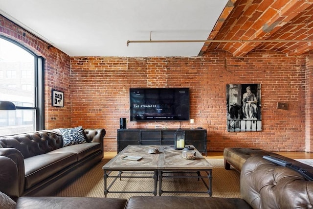 121-123 Beach St Unit 603, Boston, MA 02111 - living room with healthy amount of natural light, wood finished floors, and brick wall