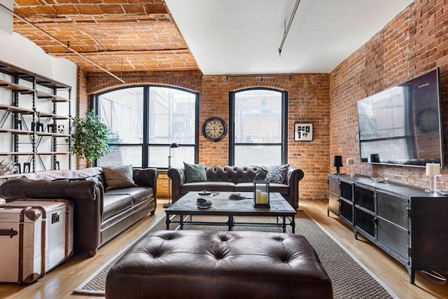 121-123 Beach St Unit 603, Boston, MA 02111 - living area with light wood-style floors and brick wall
